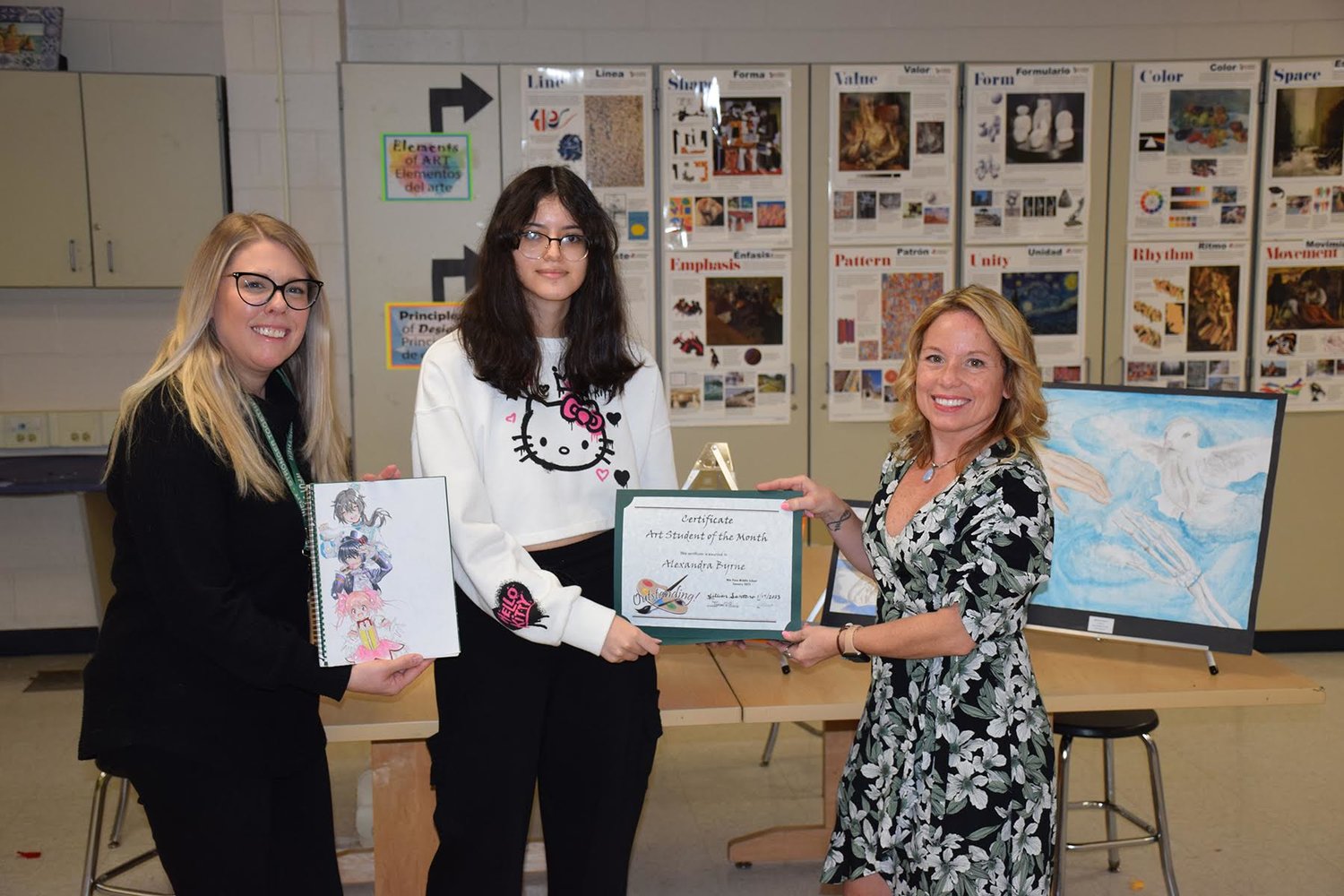 William Paca Middle School eighth-grade student Alexandra Byrne is the William Floyd “Artist of the Month” for January! Alexandra is pictured with her teacher, Jillian Santoro (left), and Fine Arts chairperson, Theresa Bianco.